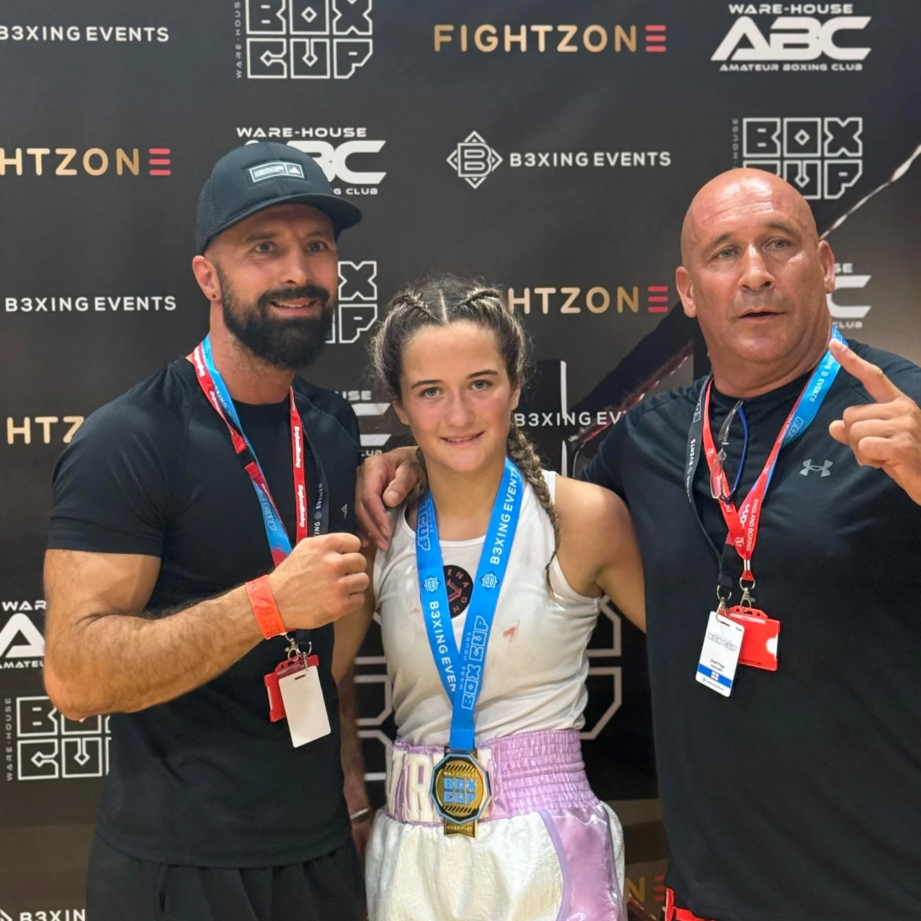 Arena boxer celebrating a Box Cup victory with her coaches