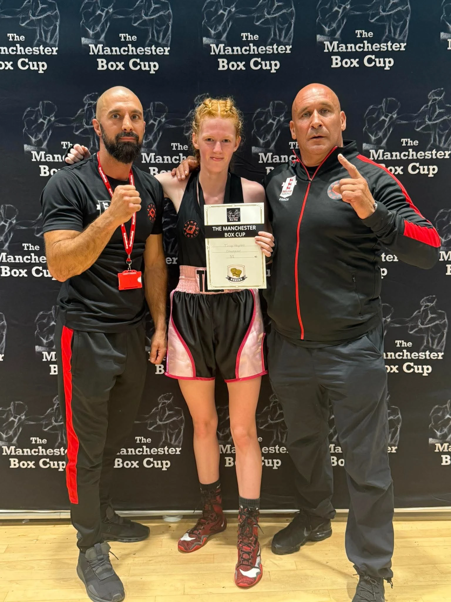 Arena boxer celebrating Manchester Box Cup success with coaches Amir Saghalati and Geoff Page